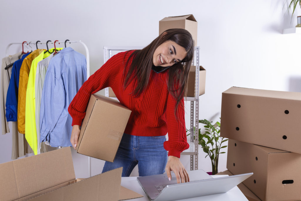Young Woman, Owener Of Small Business Packing Product In Boxes, Preparing It For Delivery. Women Packing Package With Her Products That She Selling Online - OFFICE CONT - Contabilidade Digital para você e sua empresa